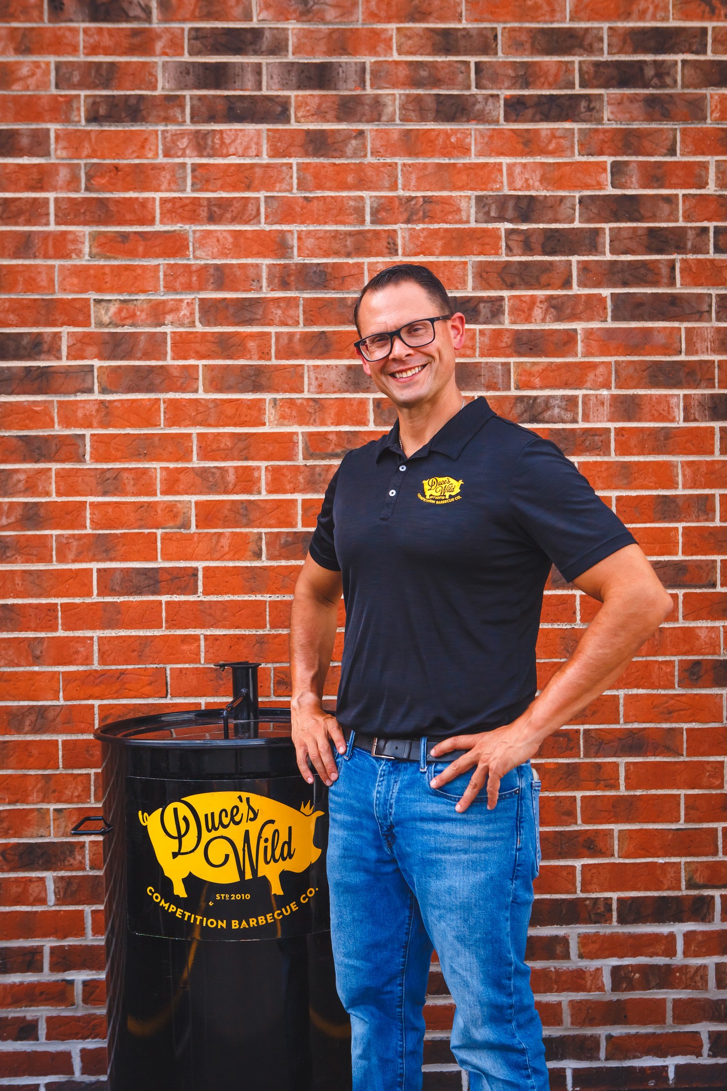 Pitmaster Duce Raymond standing beside his Duce's Wild competition smoker